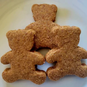 Three teddy bears are sitting on a plate.