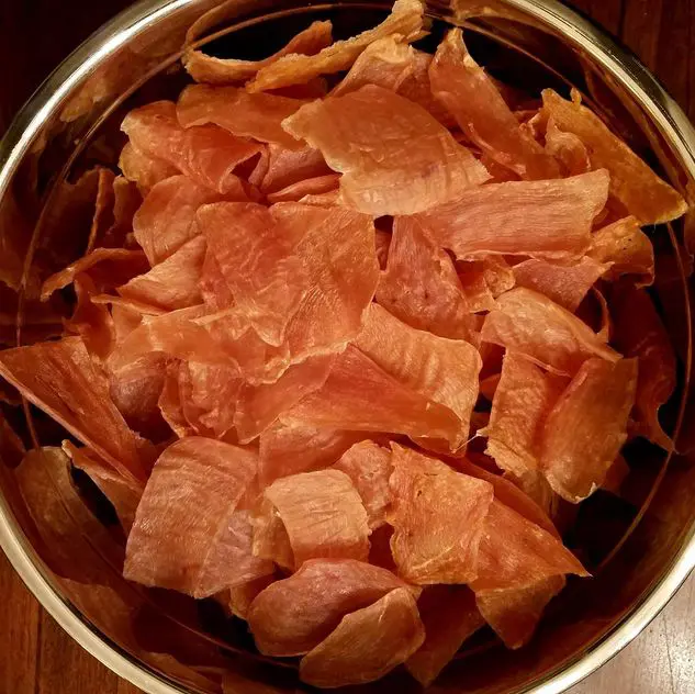 A bowl of food that is on the table.